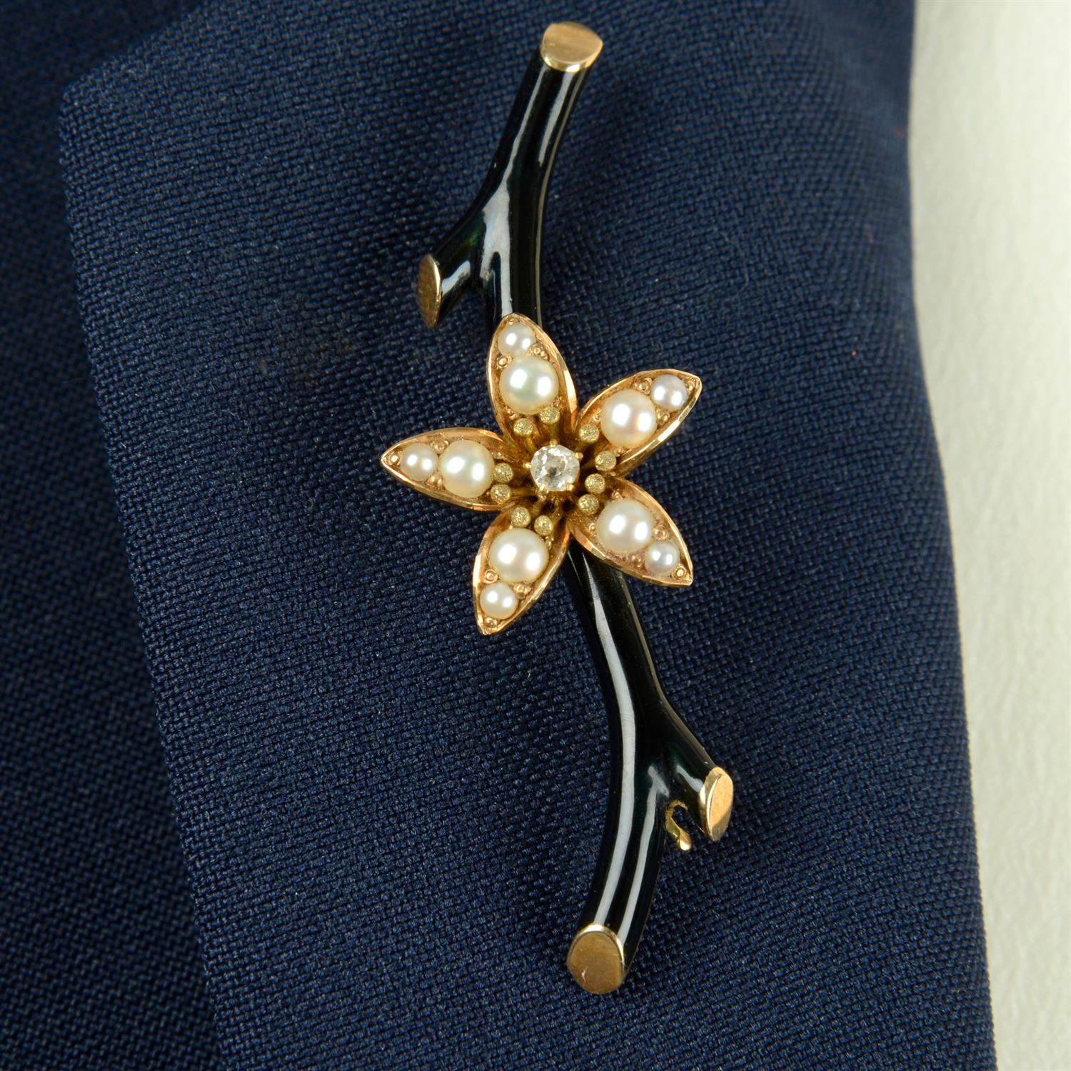 A late 19th century 14ct gold old-cut diamond and split pearl flowering black enamel branch brooch.