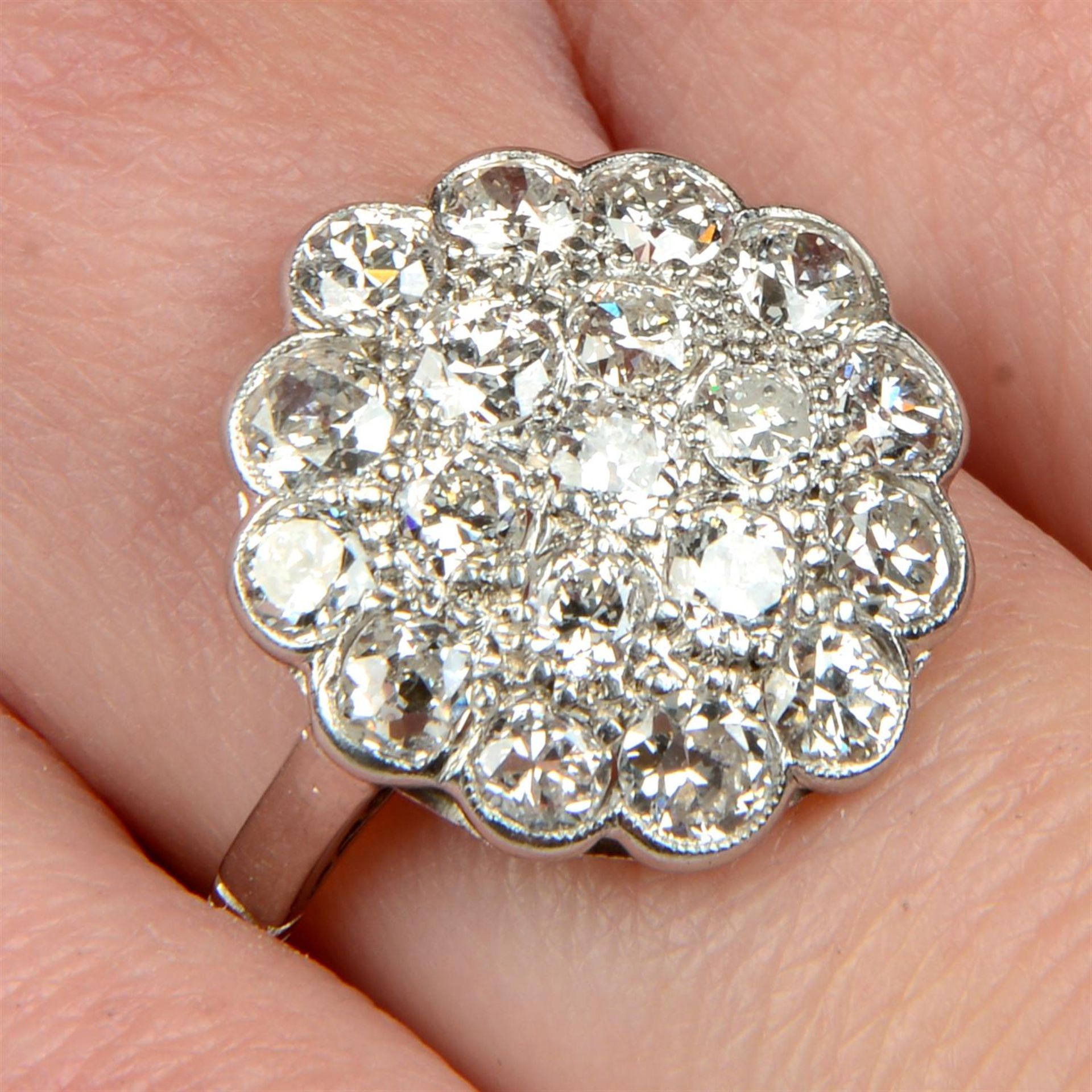 An early to mid 20th century platinum circular-cut diamond cluster ring.