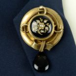 A late Victorian gold black enamel and split pearl locket brooch, with ribbon surround and onyx