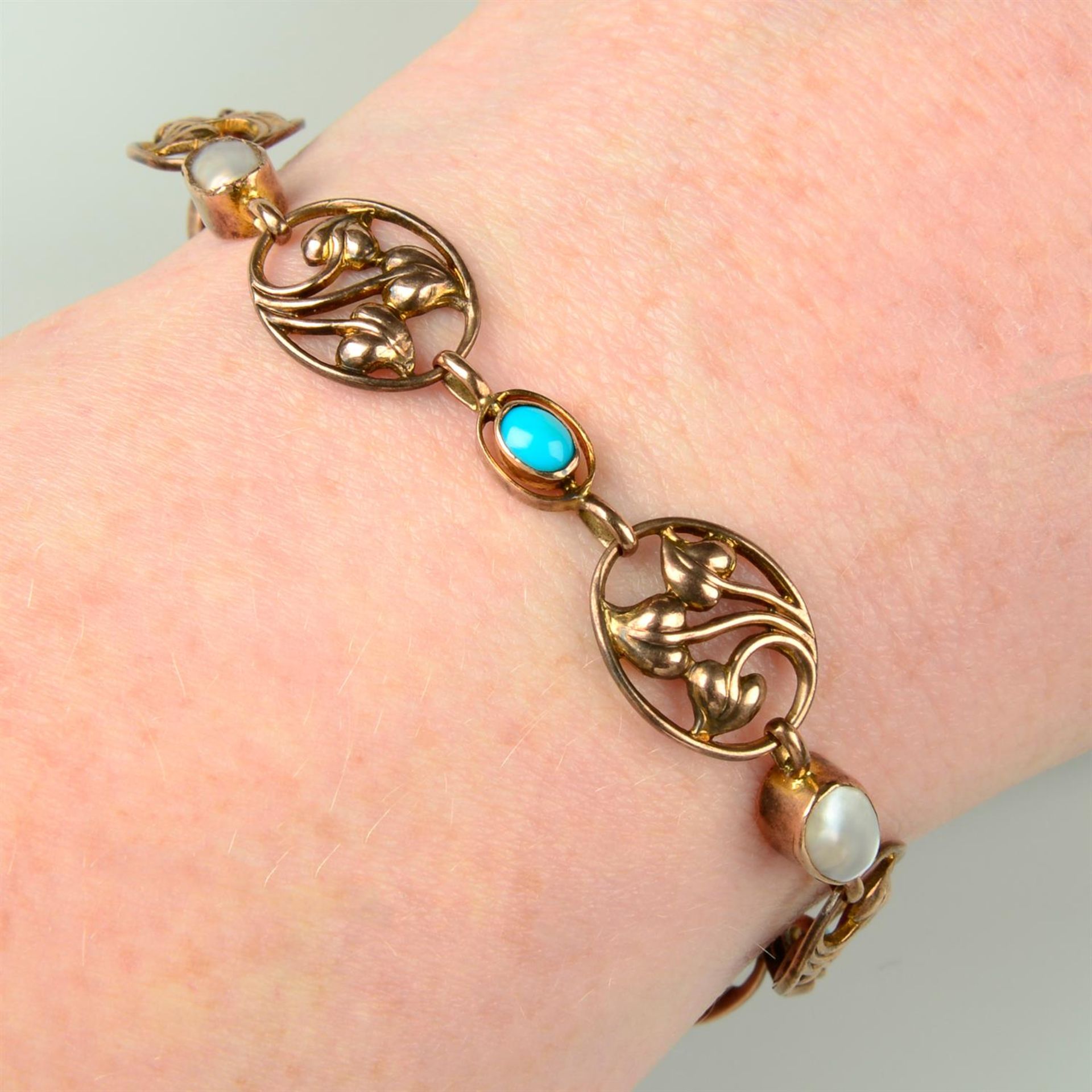 An Edwardian Art Nouveau 9ct gold turquoise and blister pearl foliate bracelet, with padlock clasp.