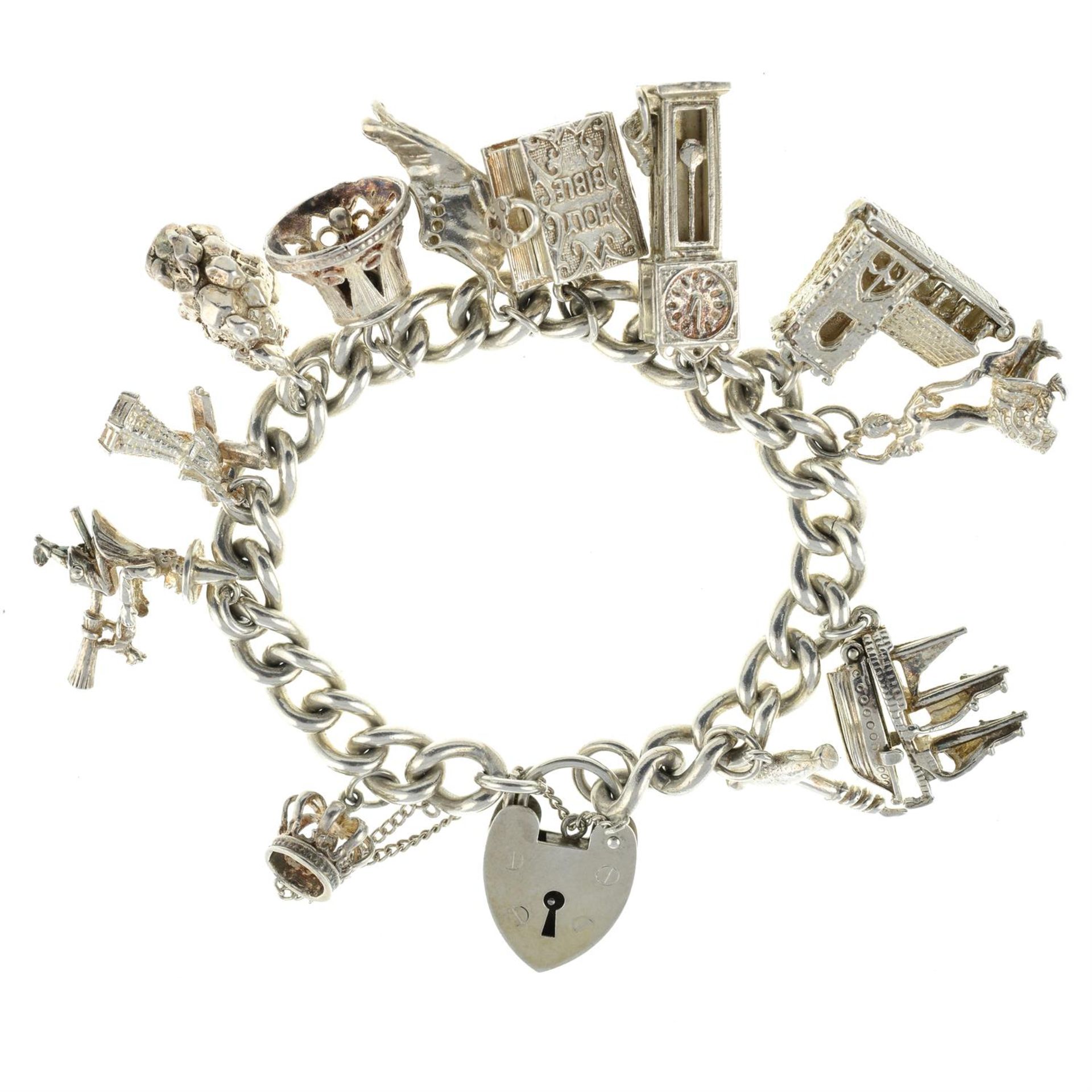 A 1970s silver charm bracelet, suspending twelve charms.