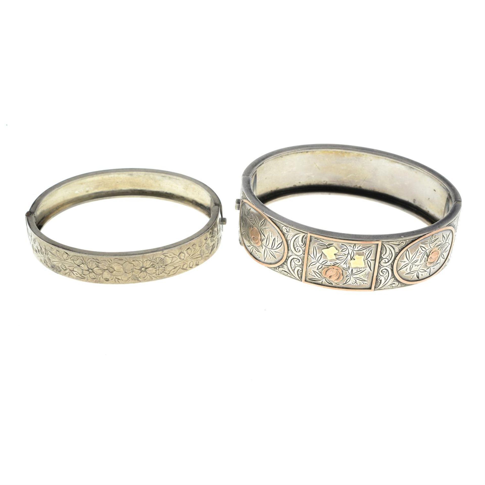 Two early 20th century silver hinged bangles.