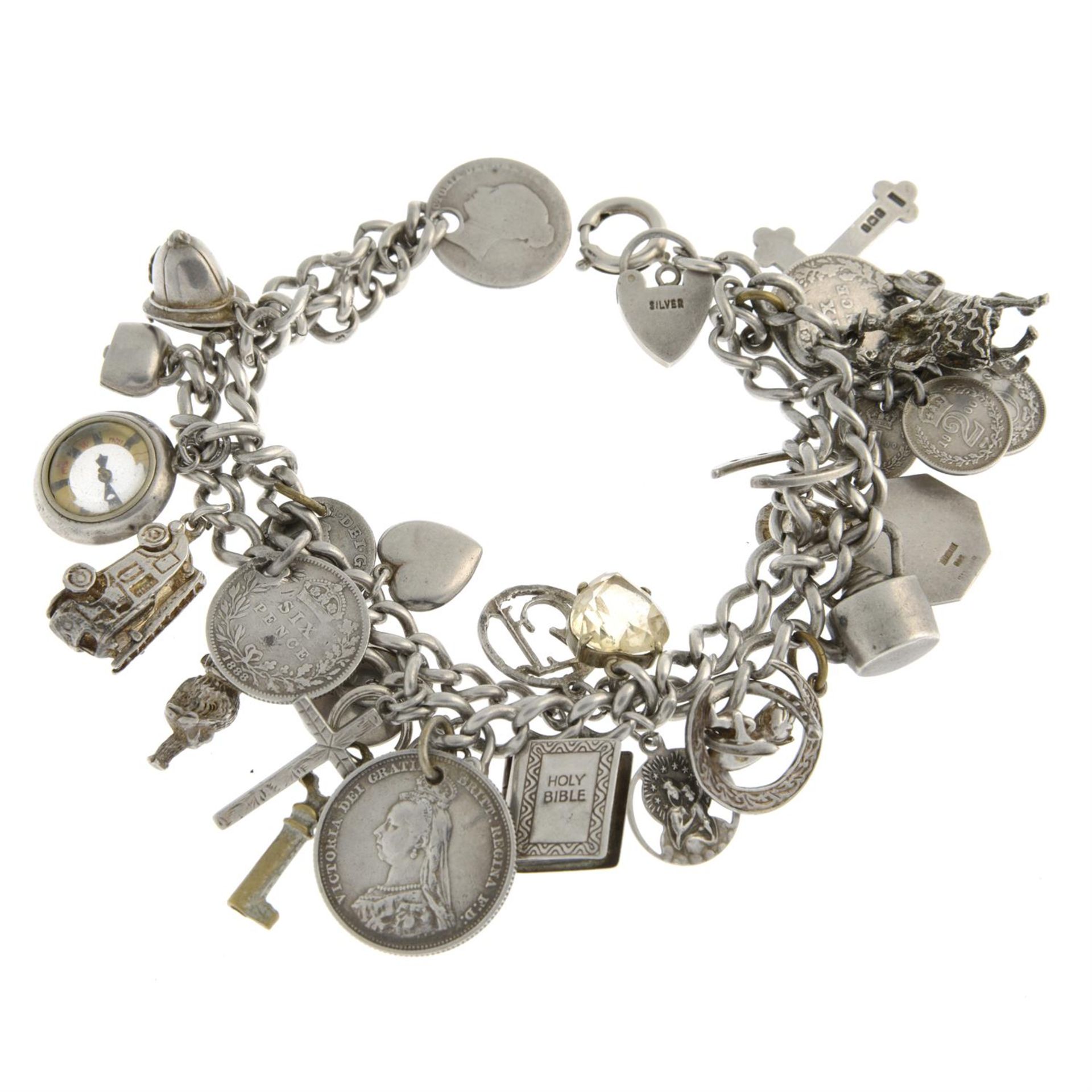 A silver two-row curb-link bracelet, suspending a selection of charms.