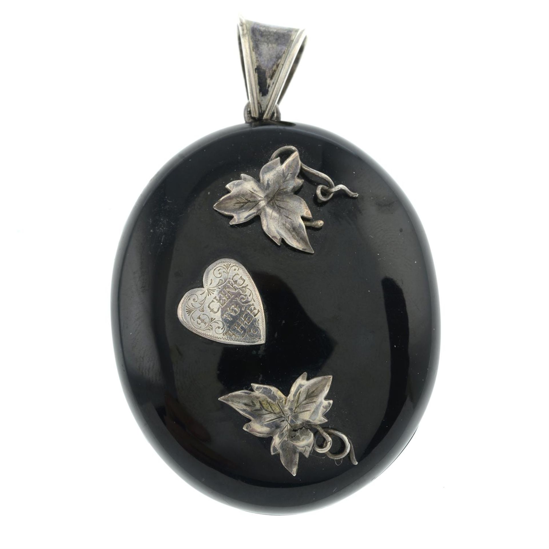 A mid Victorian silver jet mourning locket pendant, engraved 'I Cling To Thee'.