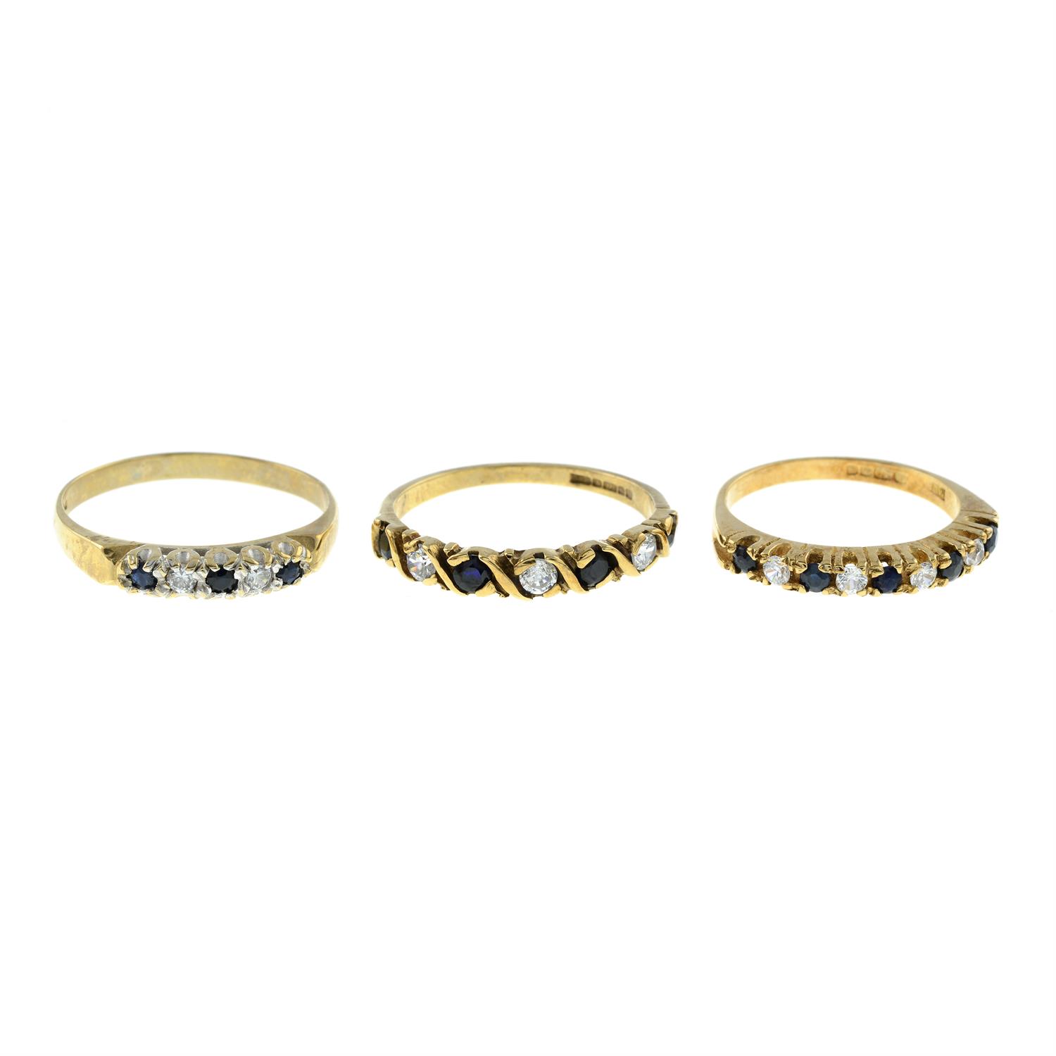 Three 9ct gold sapphire and cubic zirconia half-eternity rings.