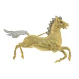 A 1970s 18ct gold galloping horse brooch, with diamond highlights.