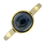 A sapphire cabochon single-stone ring.