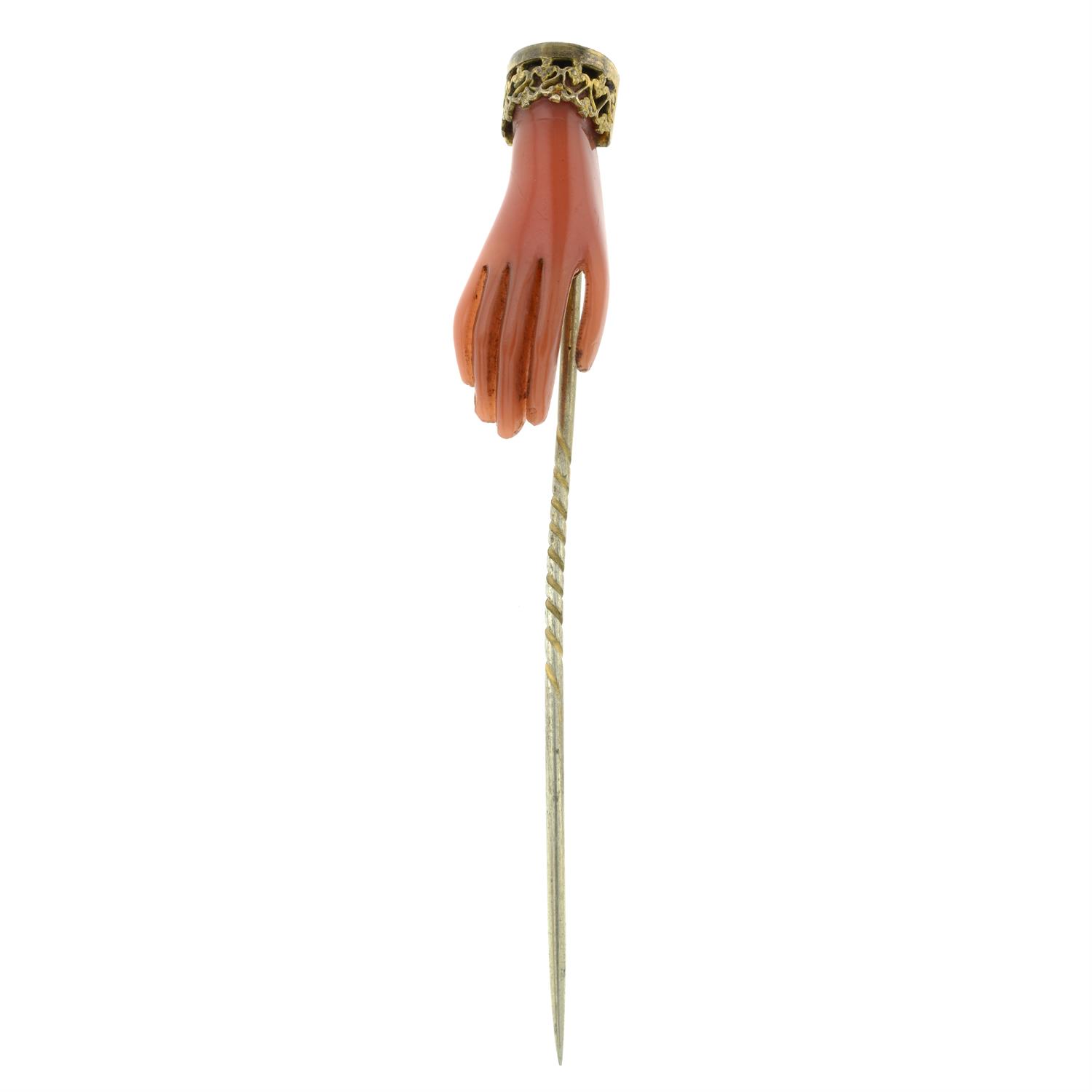 A 19th century stick pin, with carved hand detail.