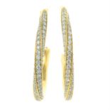 A pair of 18ct gold pave-set diamond twisted hoop earrings.