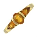 A citrine three-stone ring.