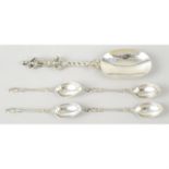 A late Victorian silver figural serving spoon; together with a set of four Victorian silver Apostle