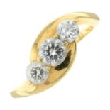 A brilliant-cut diamond three-stone crossover ring.