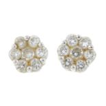 A pair of diamond floral cluster stud earrings.