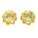 A pair of yellow paste stud earrings.