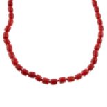 A mid 20th century faceted coral bead single-strand necklace, with 18ct gold clasp.