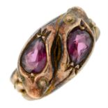 An Edwardian 9ct gold double snake ring, with garnet crests.