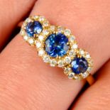 An 18ct gold graduated sapphire three-stone ring, with brilliant-cut diamond shared surround.