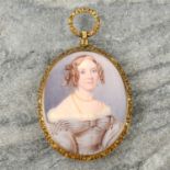 A late Georgian or Regency portrait miniature pendant of a young woman with ringlets in her hair,