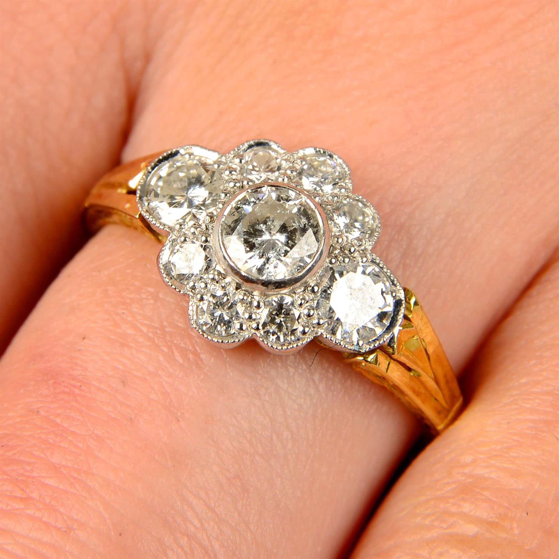 An 18ct gold brilliant-cut diamond cluster ring.