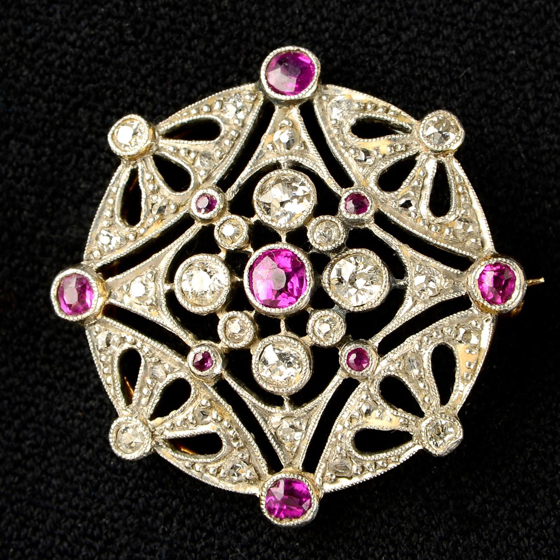 An Edwardian platinum and gold ruby, rose and old-cut diamond openwork brooch.