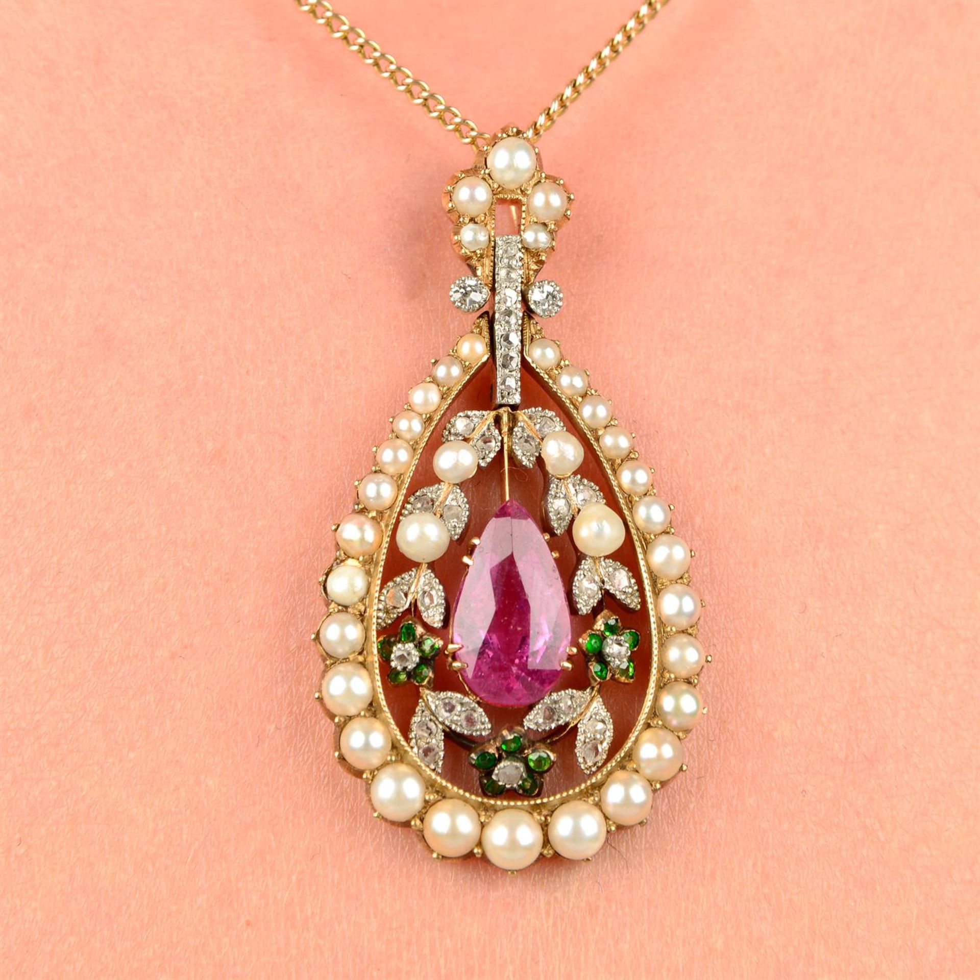 An Edwardian gold pink tourmaline, green garnet, seed pearl and rose-cut diamond openwork drop