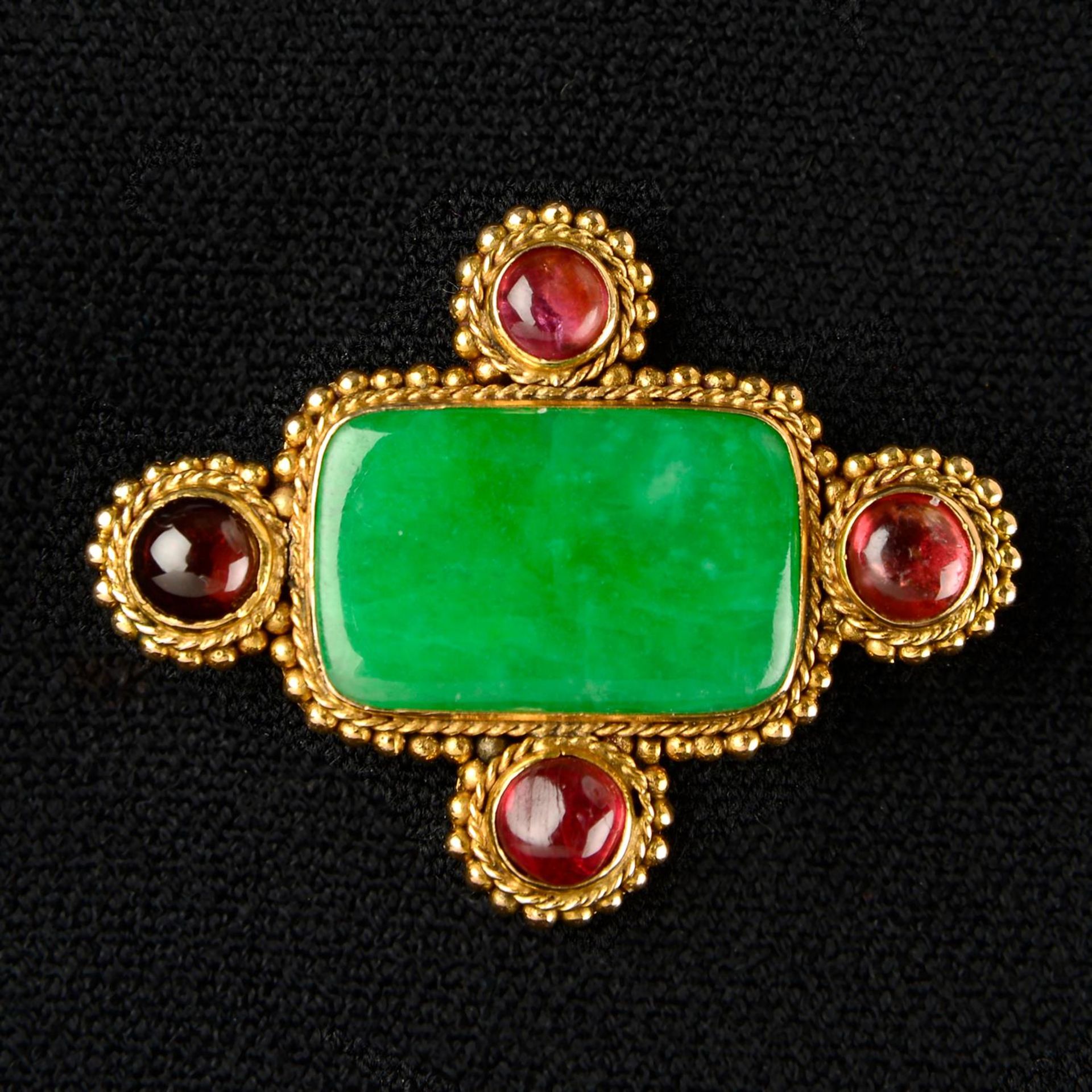 A mid 20th century gold jade and garnet panel brooch.