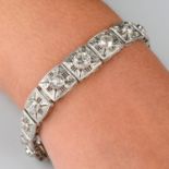 An early to mid 20th century platinum graduated old-cut diamond collet, pierced geometric bracelet.