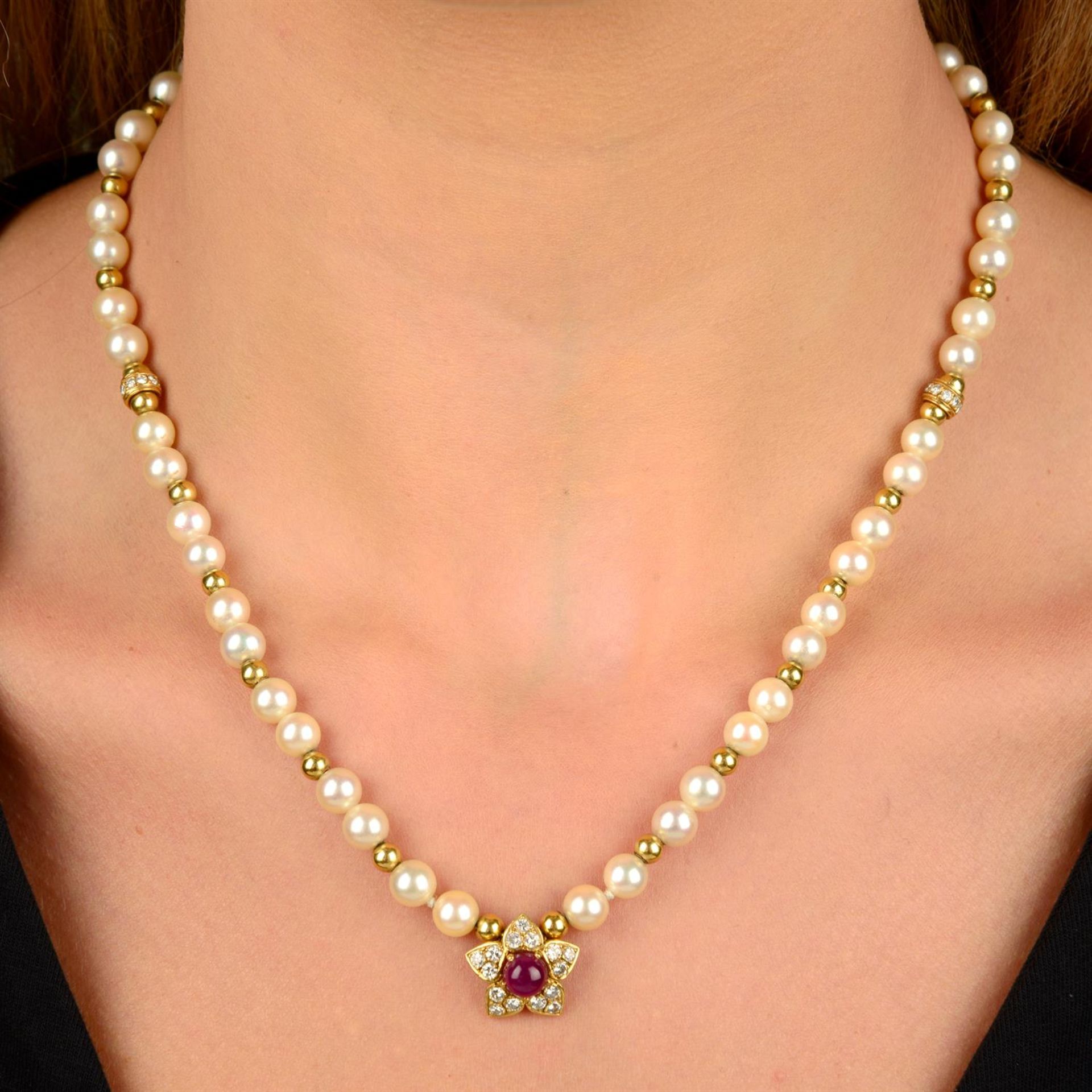 A cultured pearl single-strand necklace, with diamond rondelle and bead spacers, to a ruby cabochon