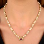 A cultured pearl single-strand necklace, with diamond rondelle and bead spacers, to a ruby cabochon