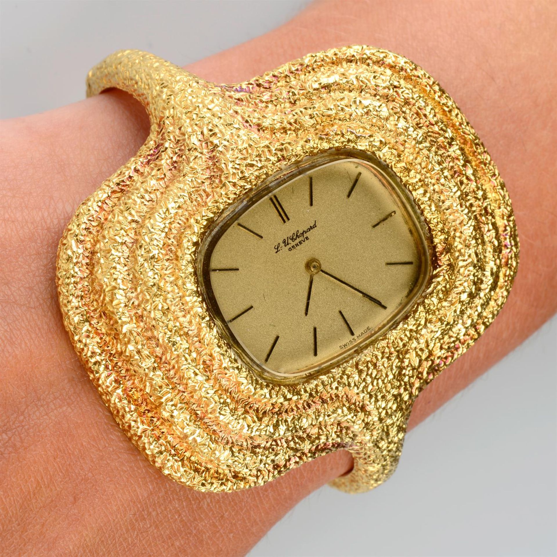 A 1970s 18ct gold watch bangle, with textured surrounds, by Chopard.