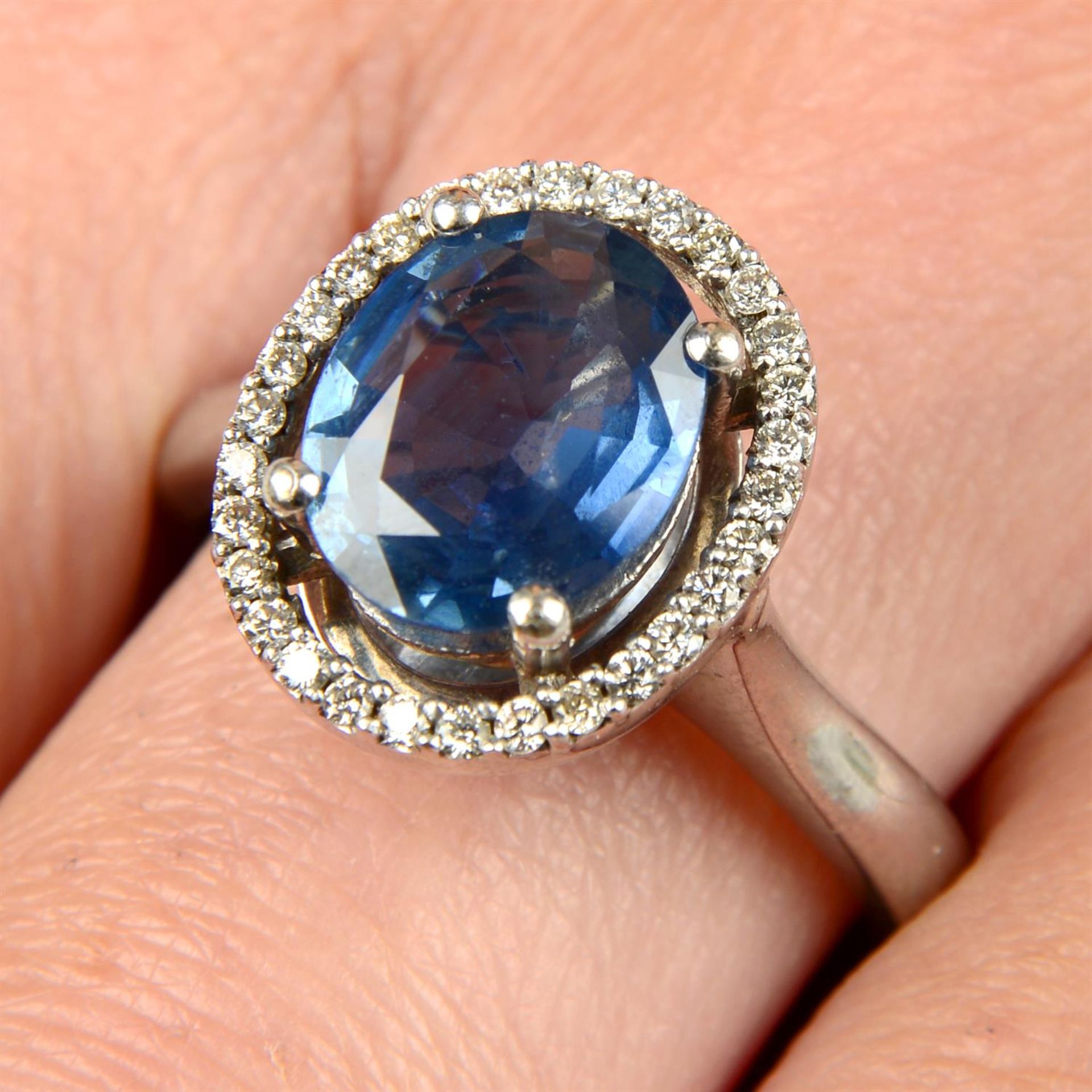 An 18ct gold sapphire and brilliant-cut diamond cluster ring.