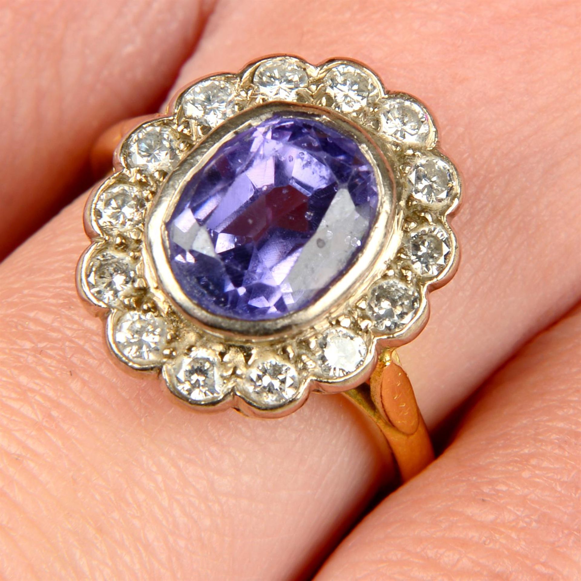 An 18ct gold Sri Lankan colour-change sapphire and brilliant-cut diamond cluster ring.