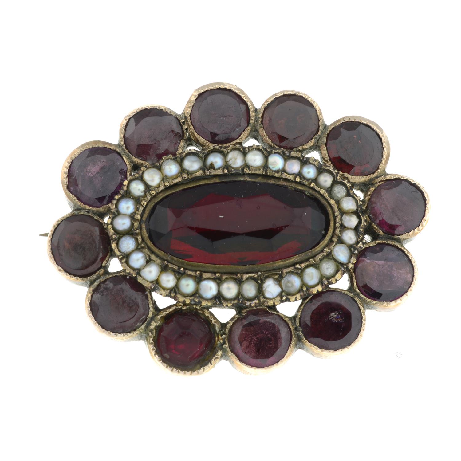 A Georgian foil-back garnet and red paste brooch.