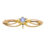 An Art Nouveau gold, sapphire and seed pearl brooch.