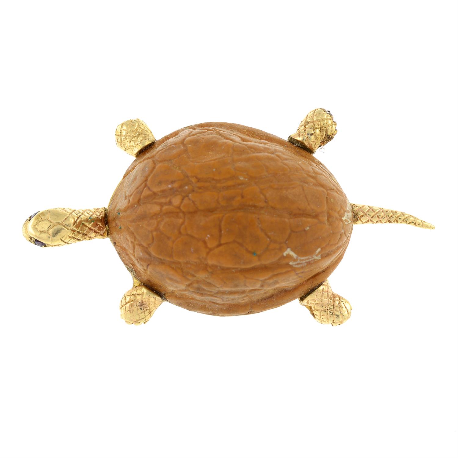 A walnut shell tortoise brooch, with ruby eyes.