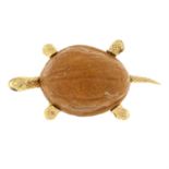 A walnut shell tortoise brooch, with ruby eyes.