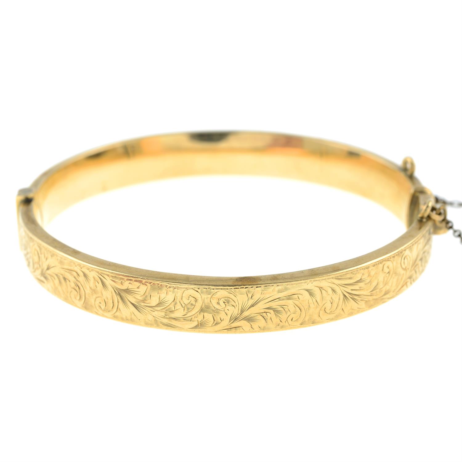 A 9ct gold scroll engrave hinged bangle, by Smith & Pepper.