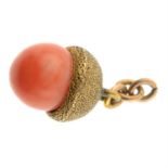 An early 20th century gold coral acorn pendant.