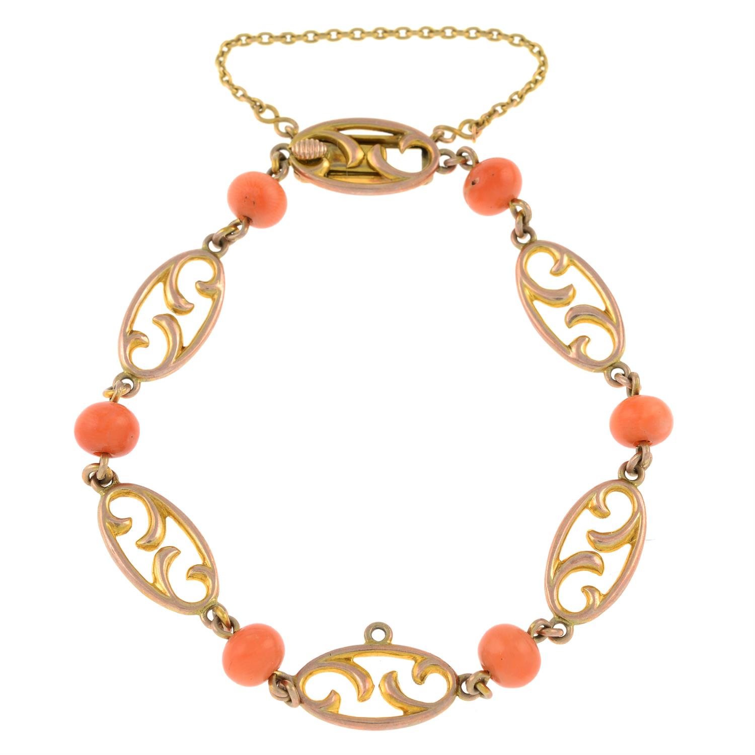 An early 20th century 9ct gold openwork link bracelet, with coral spacers.