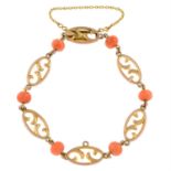 An early 20th century 9ct gold openwork link bracelet, with coral spacers.