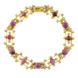 A Victorian 15ct gold garnet and split pearl openwork panel bracelet.