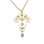 An Edwardian gold split pearl, aquamarine and blue paste openwork foliate pendant,