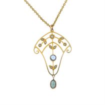 An Edwardian gold split pearl, aquamarine and blue paste openwork foliate pendant,