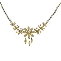An early 20th century gold seed pearl and split pearl floral necklace.