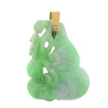 An early 20th century gold jadeite pendant, carved to depict a gourd and vine.