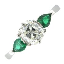An 18ct gold old-cut diamond and pear-shape emerald three-stone ring.