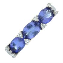 Tanzanite three-stone ring with diamond spacers