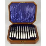 A cased Edwardian set of silver and mother-of-pearl handled fruit knives and forks.