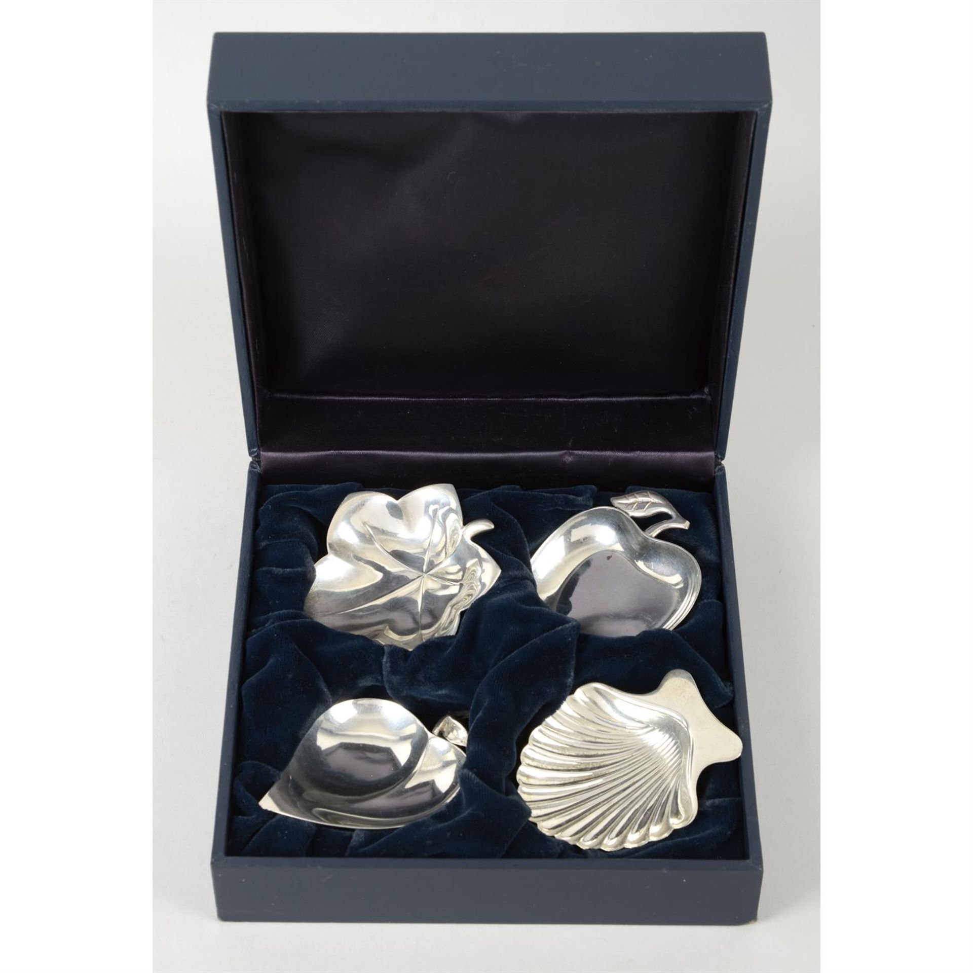 A set of four Tiffany & Co sterling silver fruit, leaf & shell dishes, in original box.