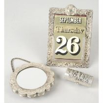 A silver mounted desk calendar; plus a small mirror on chain marked 900 & a cylindrical purse